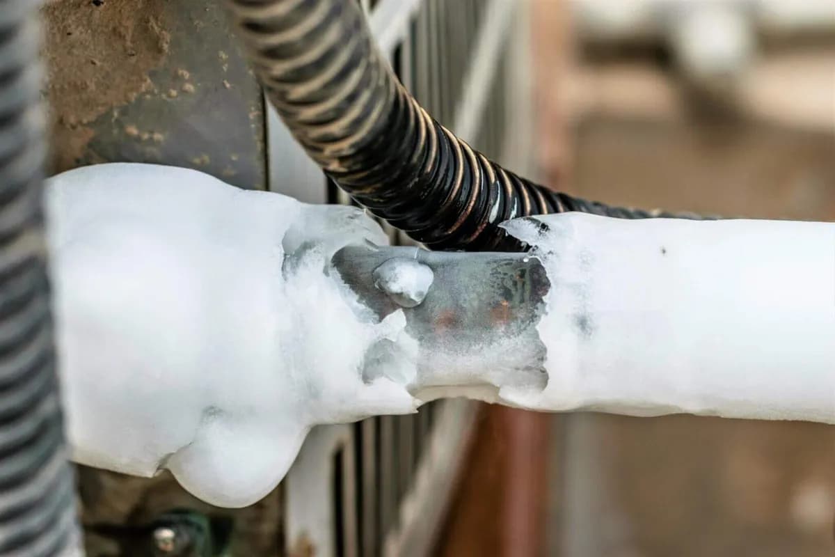 Refrigerant line frozen over with ice