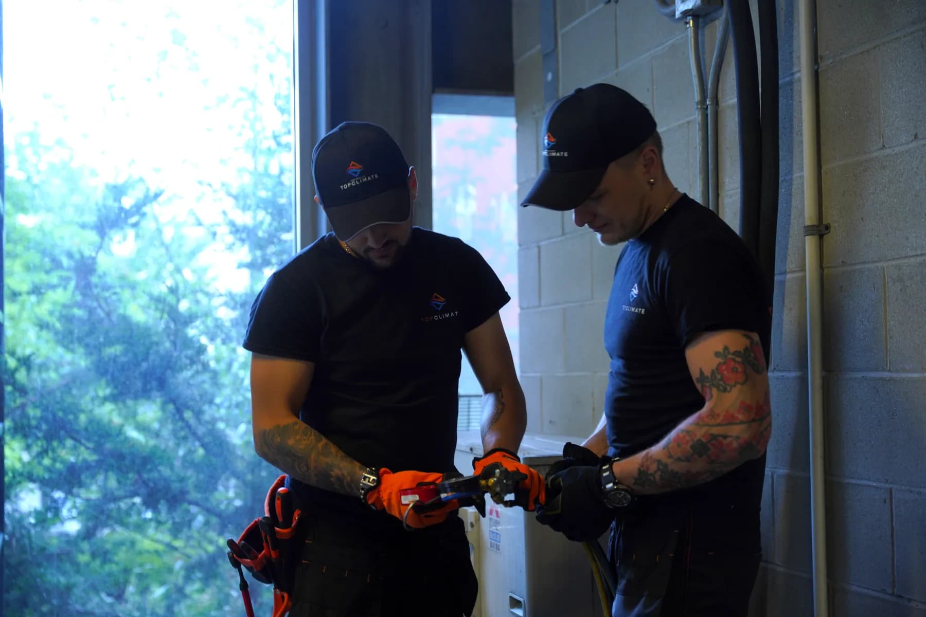 Two Top Climate technicians reviewing an outdoor unit together