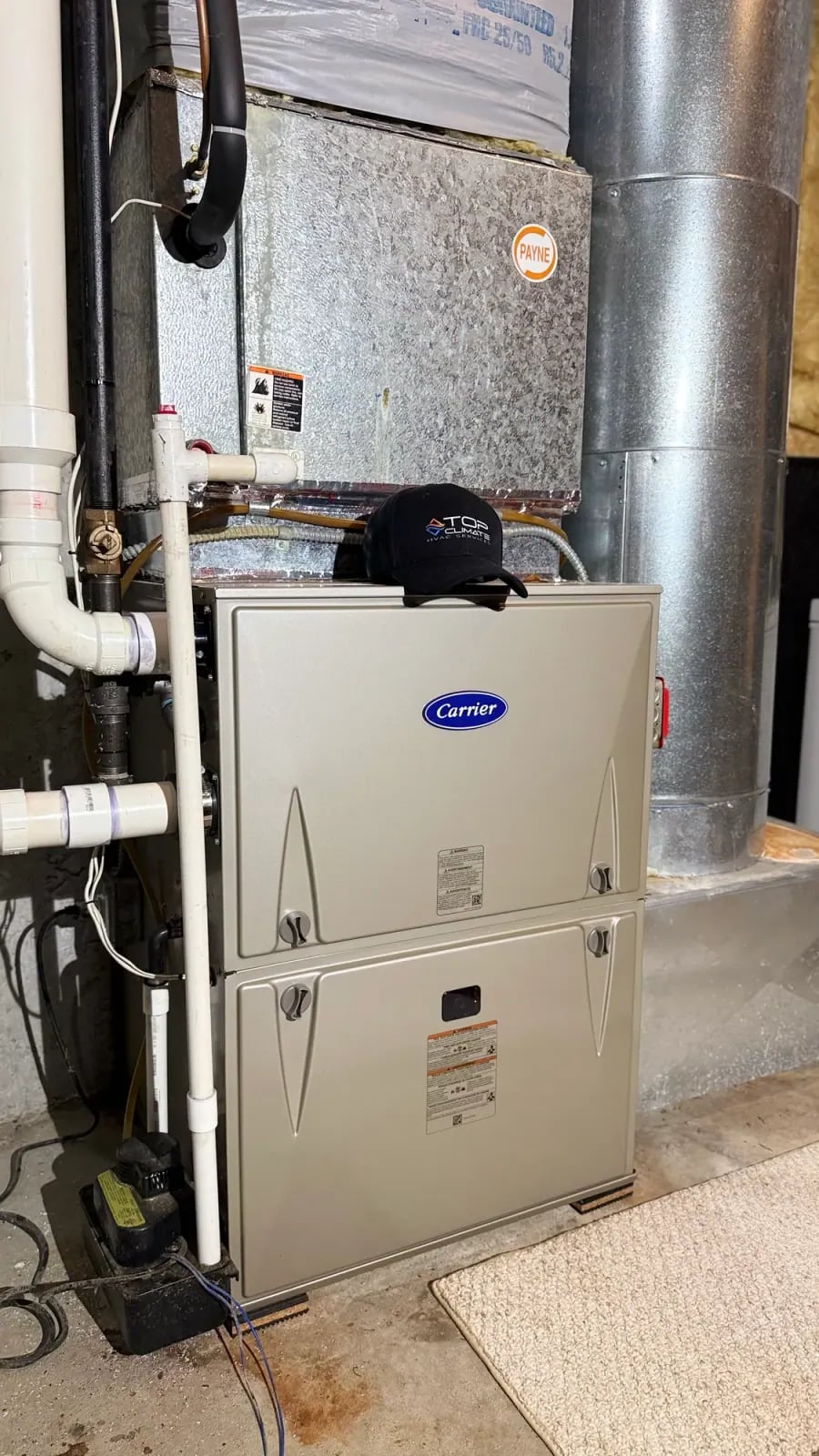 Furnace installed in a utility room with venting and drain piping